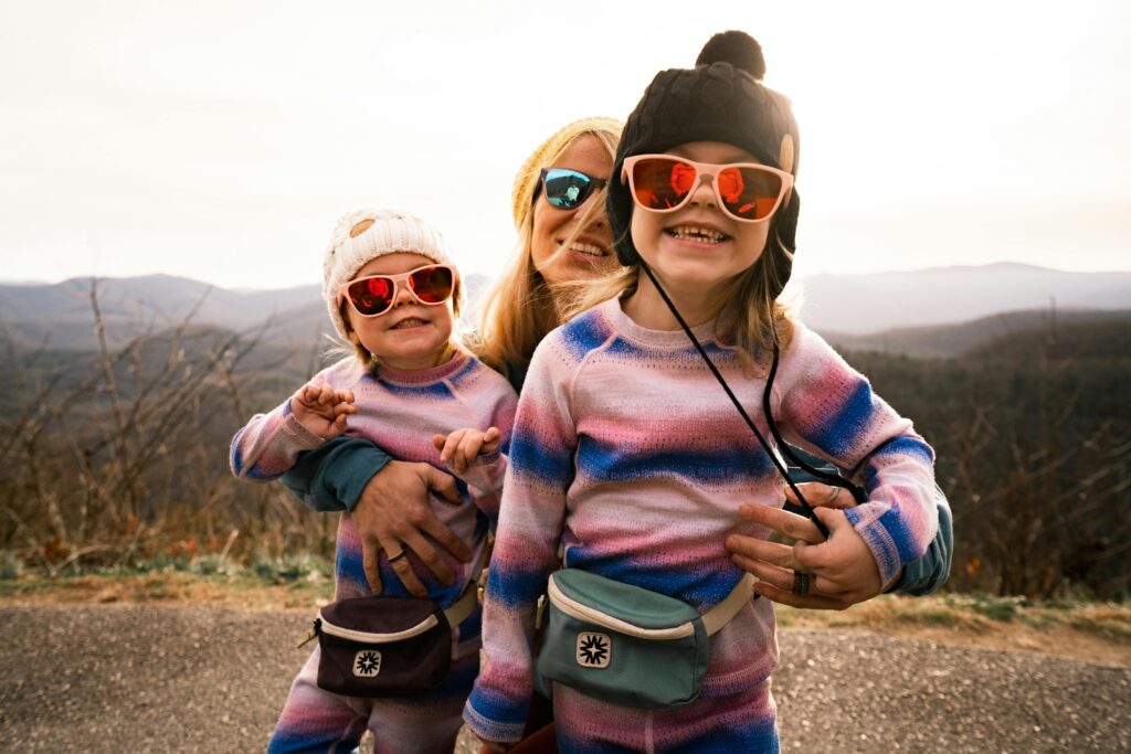 Mother and Daughters Wearing Sunglasses Having Fun on a Day trip