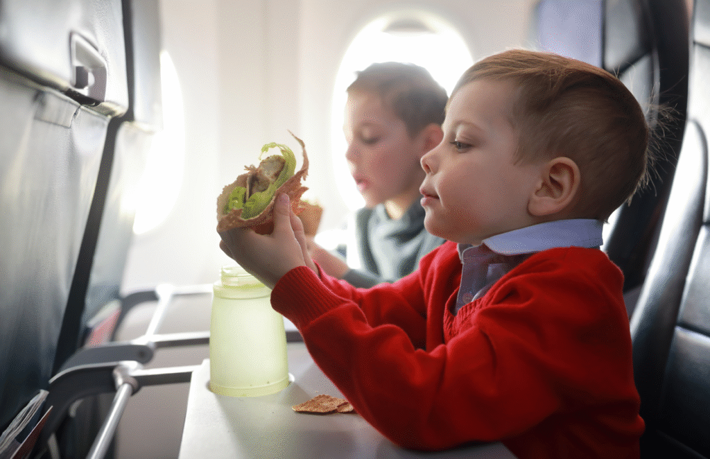 Kids eating snacks while traveling on a plane