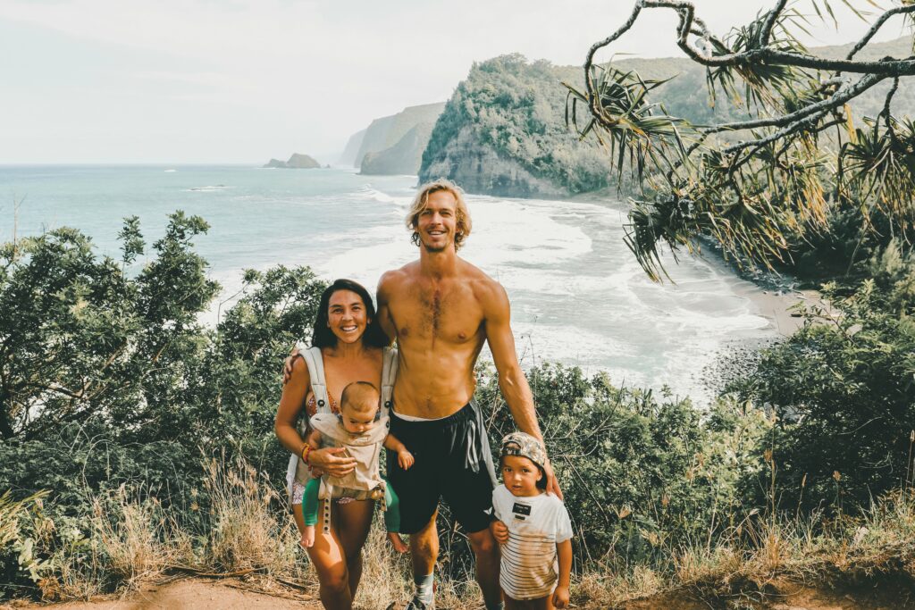 A picture of a family on a hike with a beach in the background