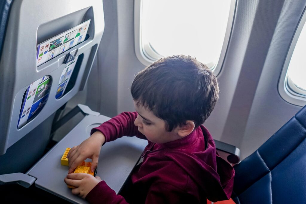 Boy playing with toy on plane
