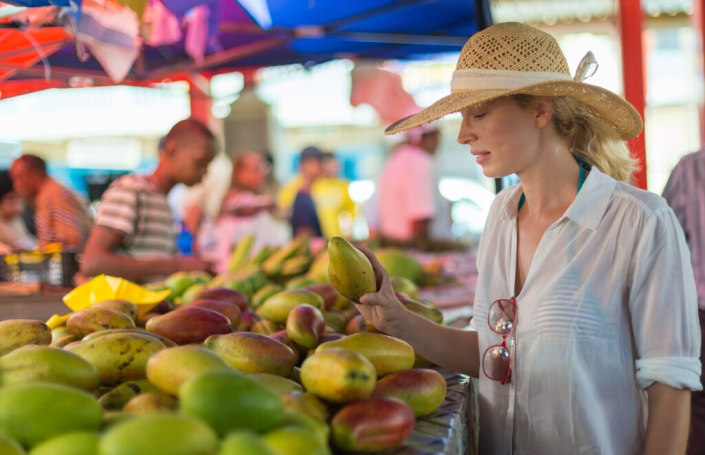 Cheap Travel Food Tips - Food Travel Shopping - A woman shopping for food at a local supermarket