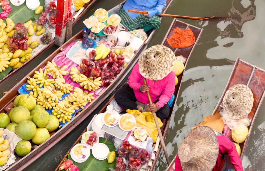 Food Travel Hacks - Floating Market Vendors in Bangkok Thailand selling fruits and vegetables