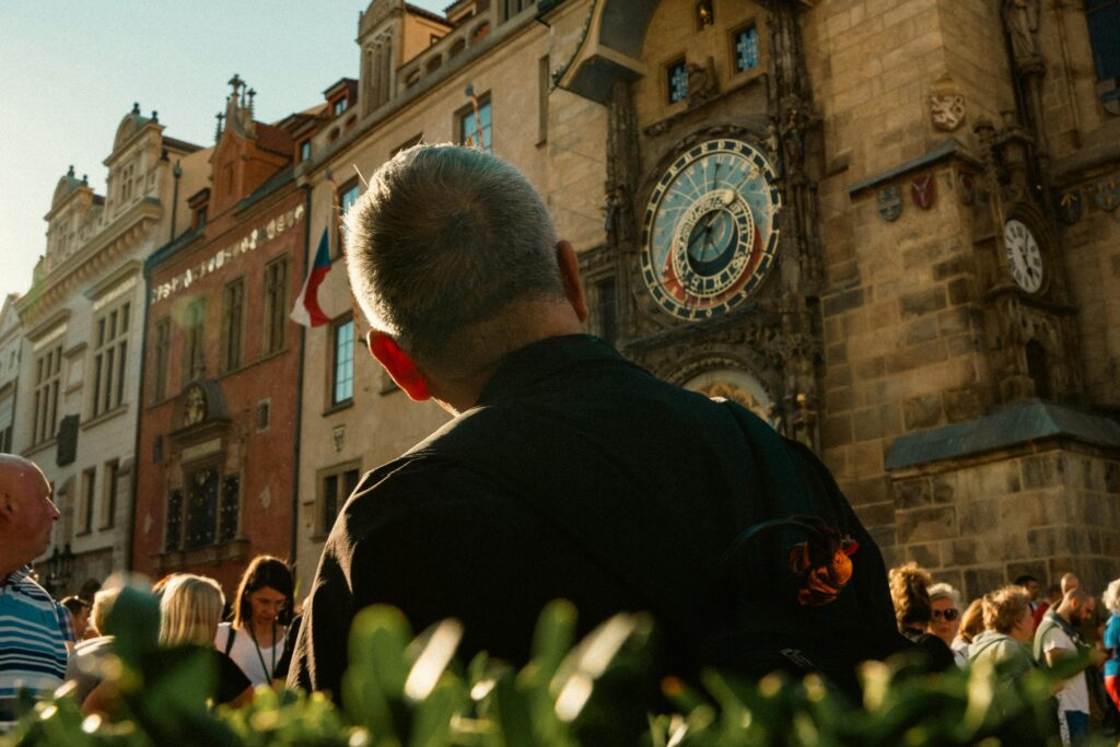 Free Attractions and Activities - A tourist enjoying a free Walking Tour admiring the Astronomical Clock in Prague
