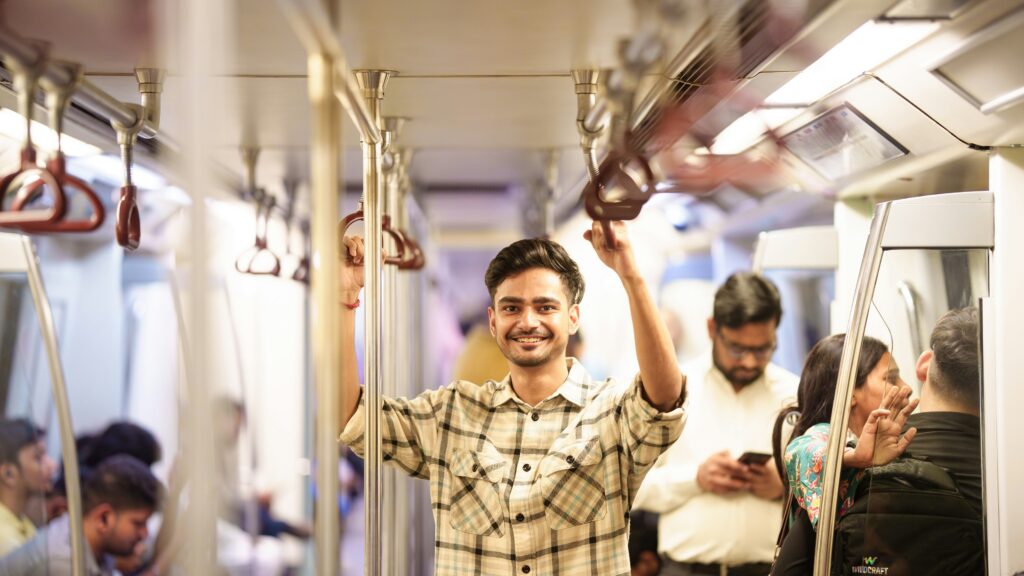 Traveletty - Public Transport for Travelers - A smiling man on board a public transport train