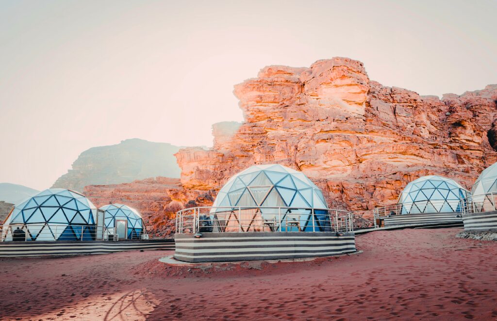 Traveletty - Bubble Dome - Featured Image - A group of bubble dome stays located in a desert