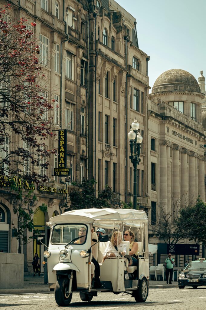 Traveletty - Common Travel Scams - tourists riding a tuk tuk vehicle to tour around the city