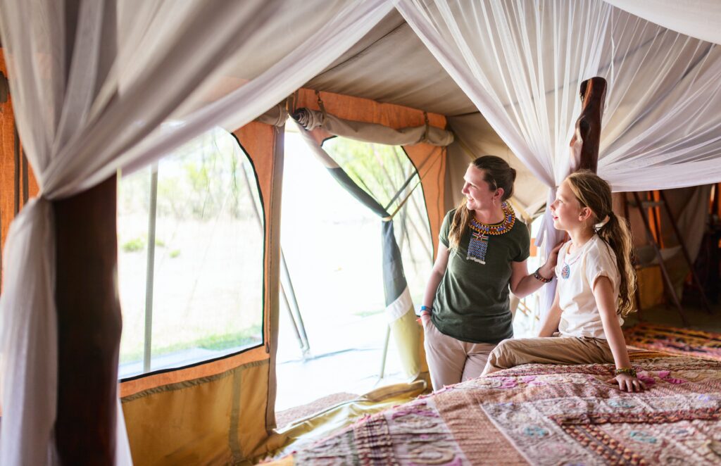 Traveletty - Safari Tents - a mother and her child in a safari tent enjoying family vacation in Africa