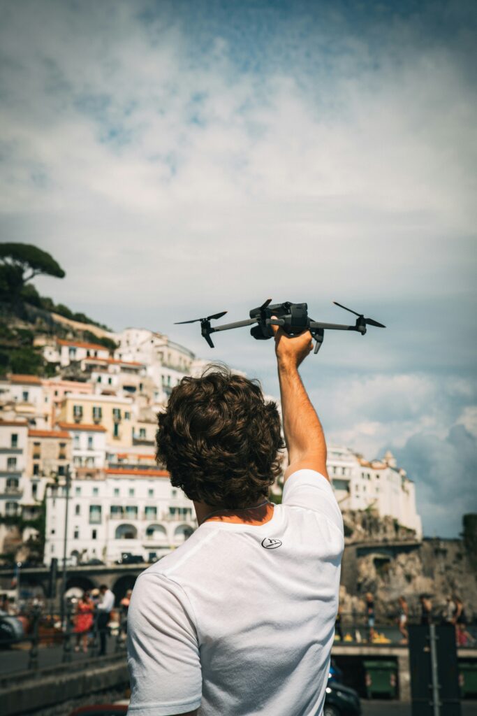 Traveletty - Travel Etiquette and Safety - a man holding a drone 
