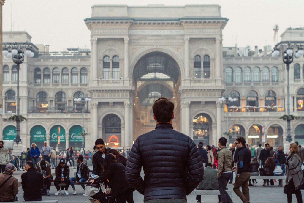 Traveletty - Travel Etiquette and Safety - a male tourist standing in downtown Milan 