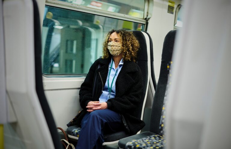 Traveletty - Travel Health and Safety - Featured Image - woman sitting on a train for safe travel
