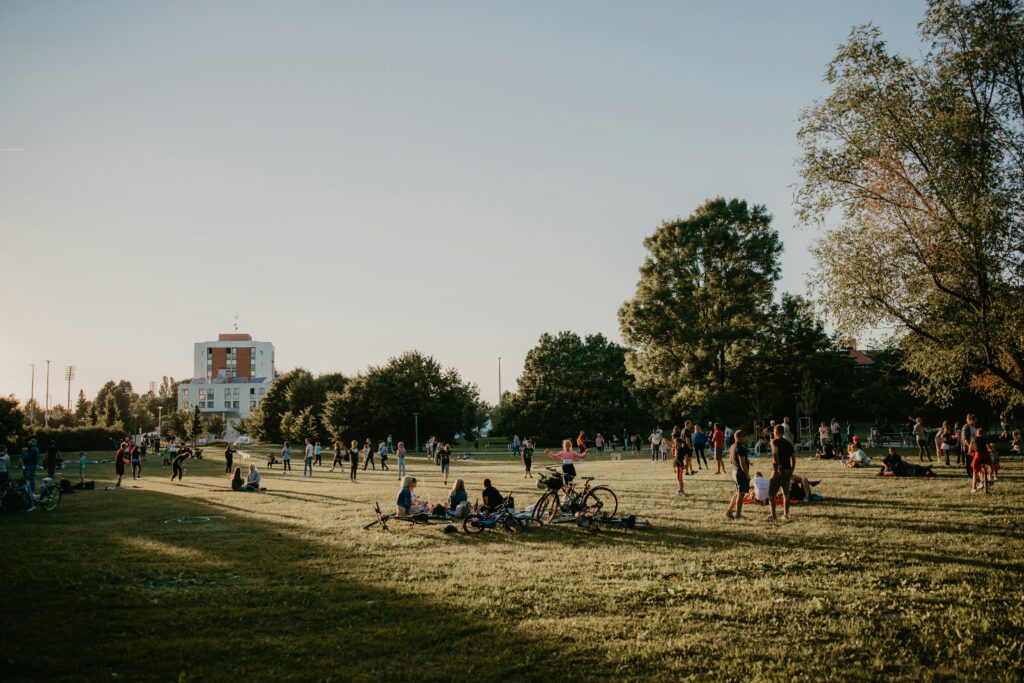 Traveletty - Urban Parks for Picnicking - A group of people doing biking activity while picnicking in an urban park