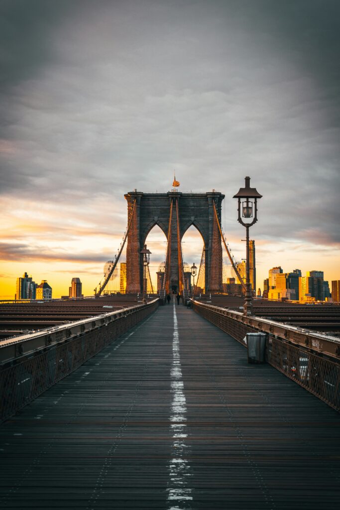 Traveletty - Budget Travel Benefits - Brookly Bridge in New York during sunrise.