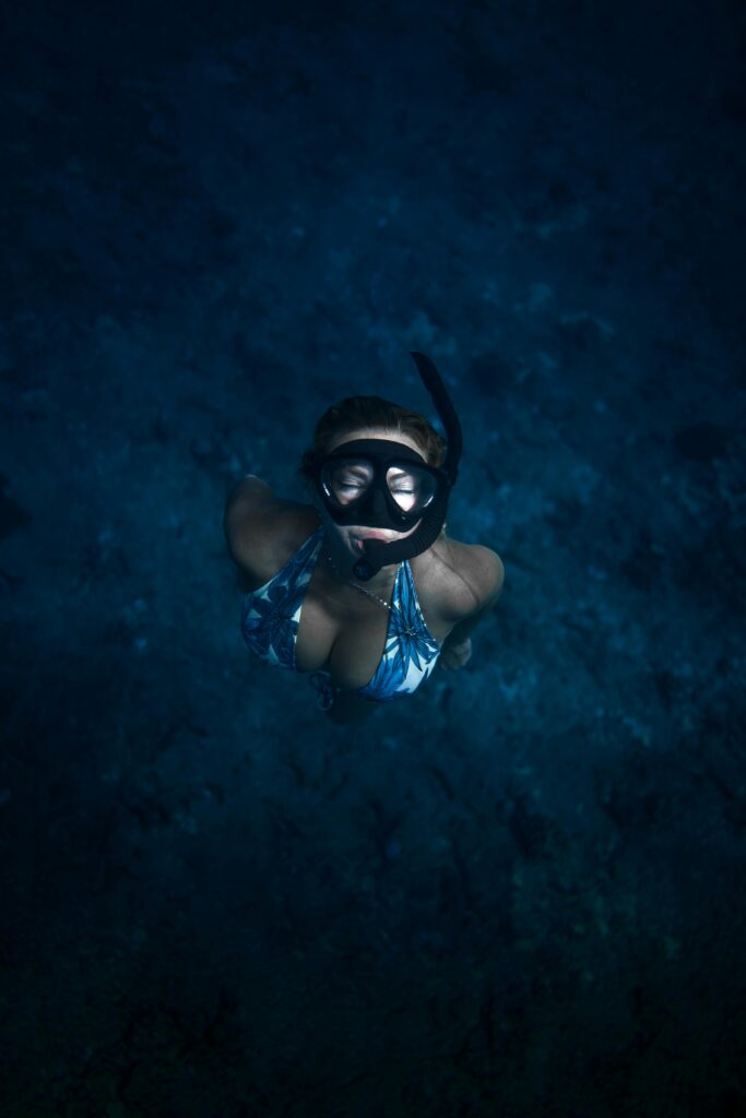 Traveletty - Dive Resorts - calm woman snorkeling in the ocean
