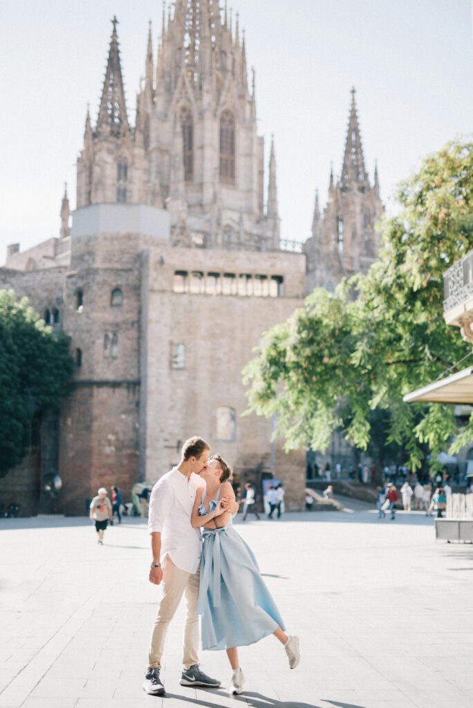 Traveletty - Romantic Travel Destination - couple kissing outside the Barcelona Cathedral in Spain